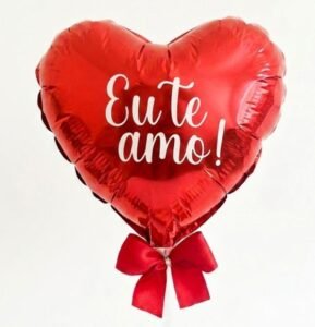 Balão metalizado vermelho em formato de coração com a frase Eu te amo em letras brancas e laço de fita. Opção romântica para personalizar cesta de presentes.
